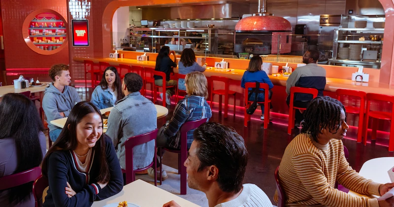 Groups of people sit in Netflix Bites and enjoy food and drink.