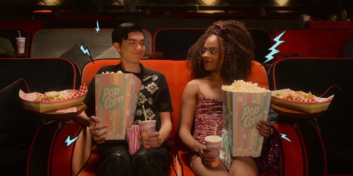 Will Gao as Tao and Yasmin Finney as Elle sit together in a movie theater in Season 2 of ‘Heartstopper.’ 