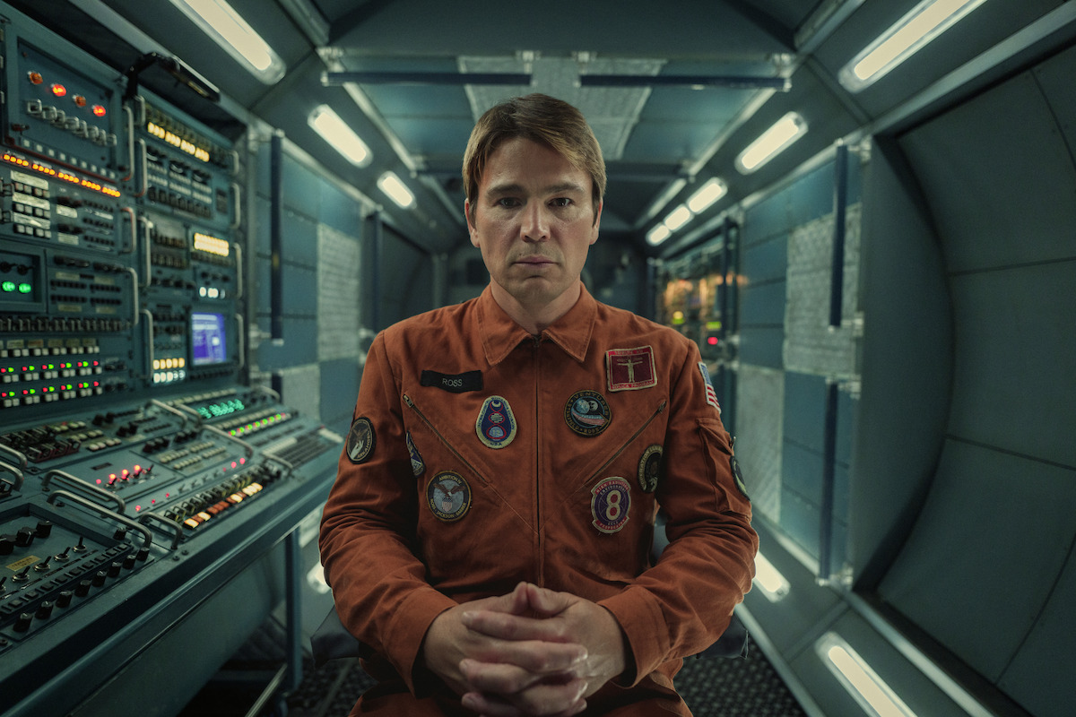 Josh Hartnett as David Ross in Black Mirror Season 6 sitting with hands folded.  