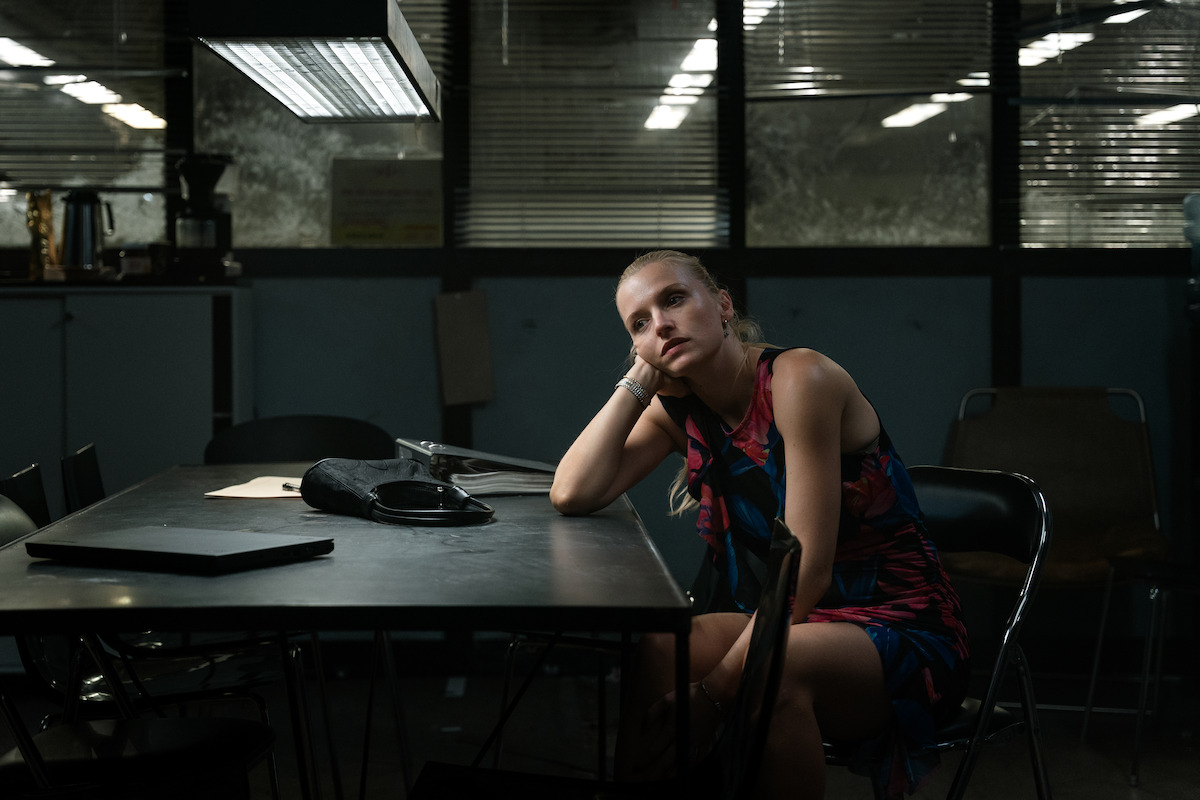 Clara Dessau as Sara/Tea waiting in a police interrogation room in ‘The Asset.’