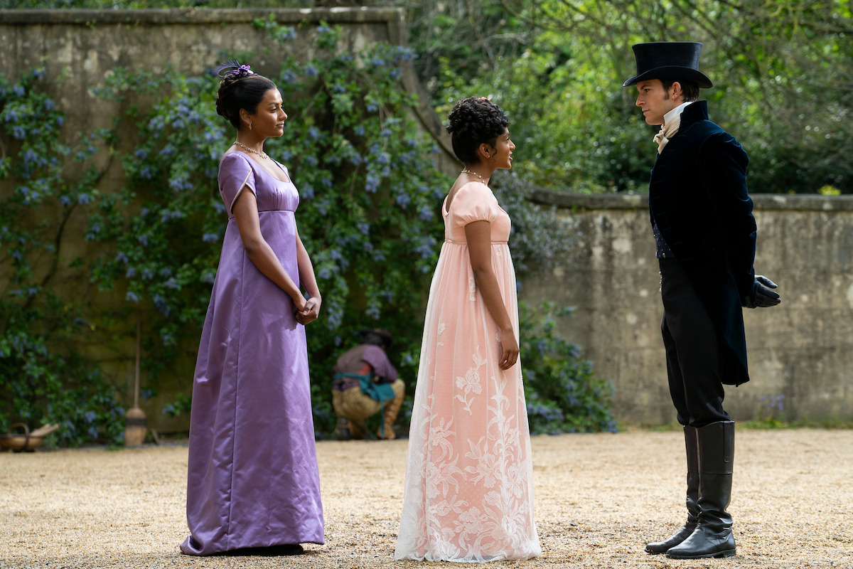 The Sharma sisters, Kate (Simone Ashley) and Edwina (Charithra Chandran) meet a top-hatted Anthony Bridgerton (Jonathan Bailey).
