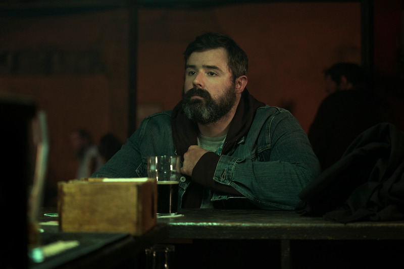 Ger Kelly as Teddy sits at a bar in 'Bodkin'