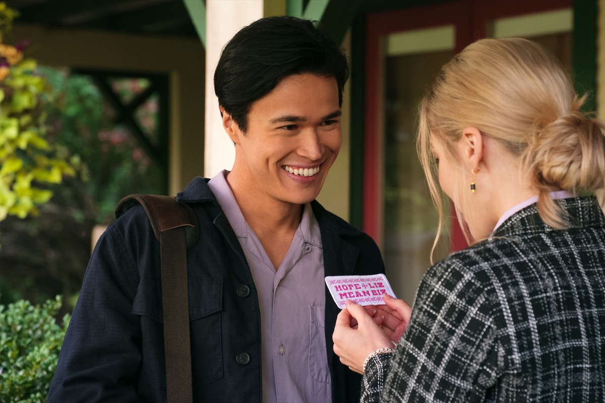 Kai Bradbury as Denny Cutler stands smiling on a porch in Season 5 of ‘Virgin River.’