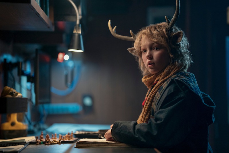 Christian Convery as Gus wears a red scarf and blue jacket in Season 3 of 'Sweet Tooth'
