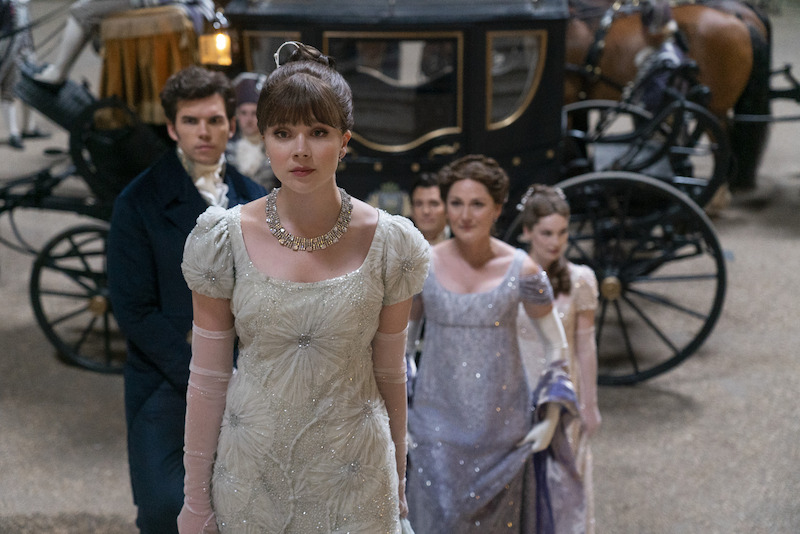 Luke Newton as Colin Bridgerton, Claudia Jessie as Eloise Bridgerton, Luke Thompson as Benedict Bridgerton, Ruth Gemmell as Lady Violet Bridgerton, and Hannah Dodd as Francesca Bridgerton depart a carriage together in season 3 of 'Bridgerton'