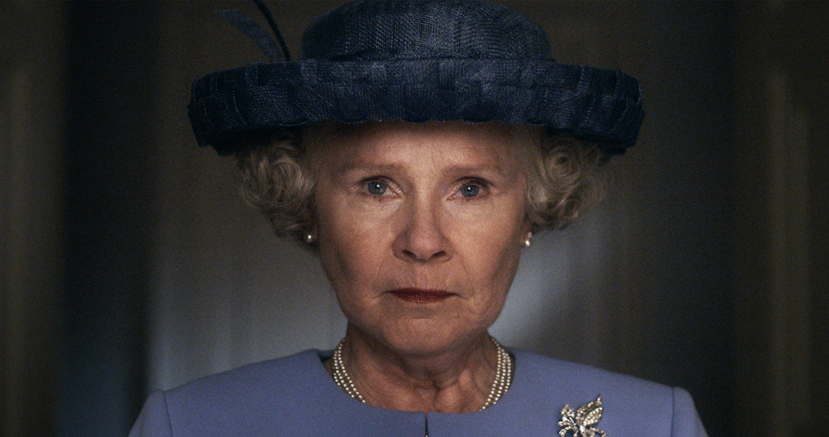 Imelda Staunton as Queen Elizabeth II in a blue dress and hat.