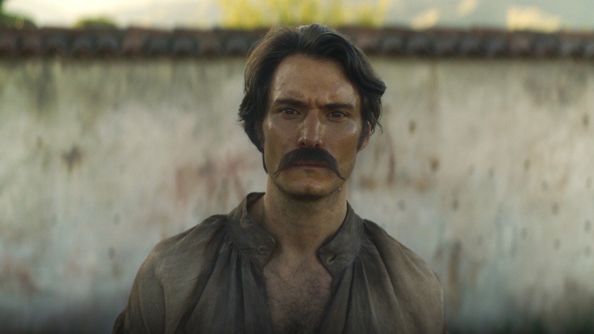 Claudio Cataño as Colonel Aureliano Buendía stands with an intense introspective expression in 'One Hundred Years of Solitude'