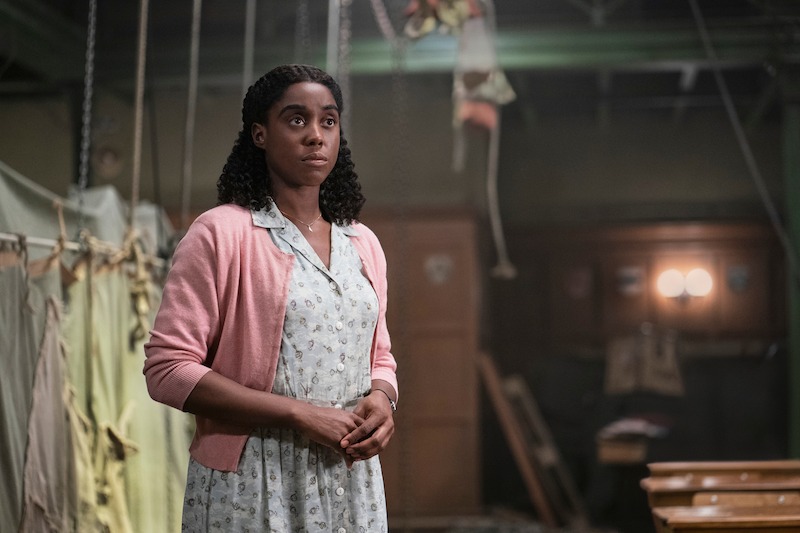 Miss Honey (Lashana Lynch) looks on.