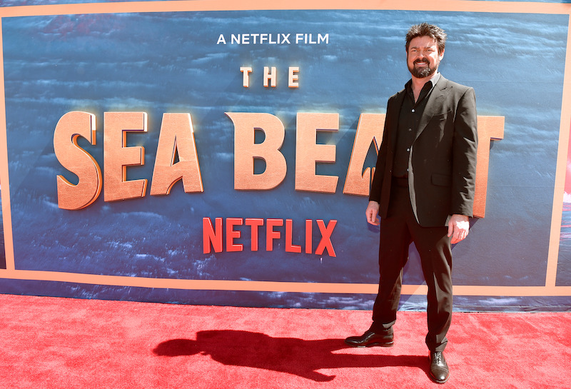 Karl Urban, who voices legendary hunter Jacob, walks the red carpet of The Sea Beast premiere.