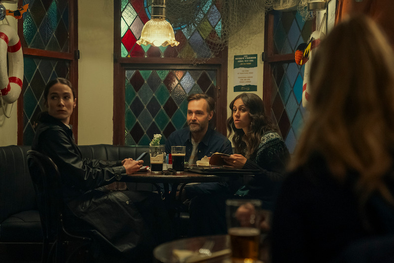 Siobhán Cullen as Dove, Will Forte as Gilbert Power, and Robyn Cara as Emmy Sizergh sit at a pub together in 'Bodkin' 