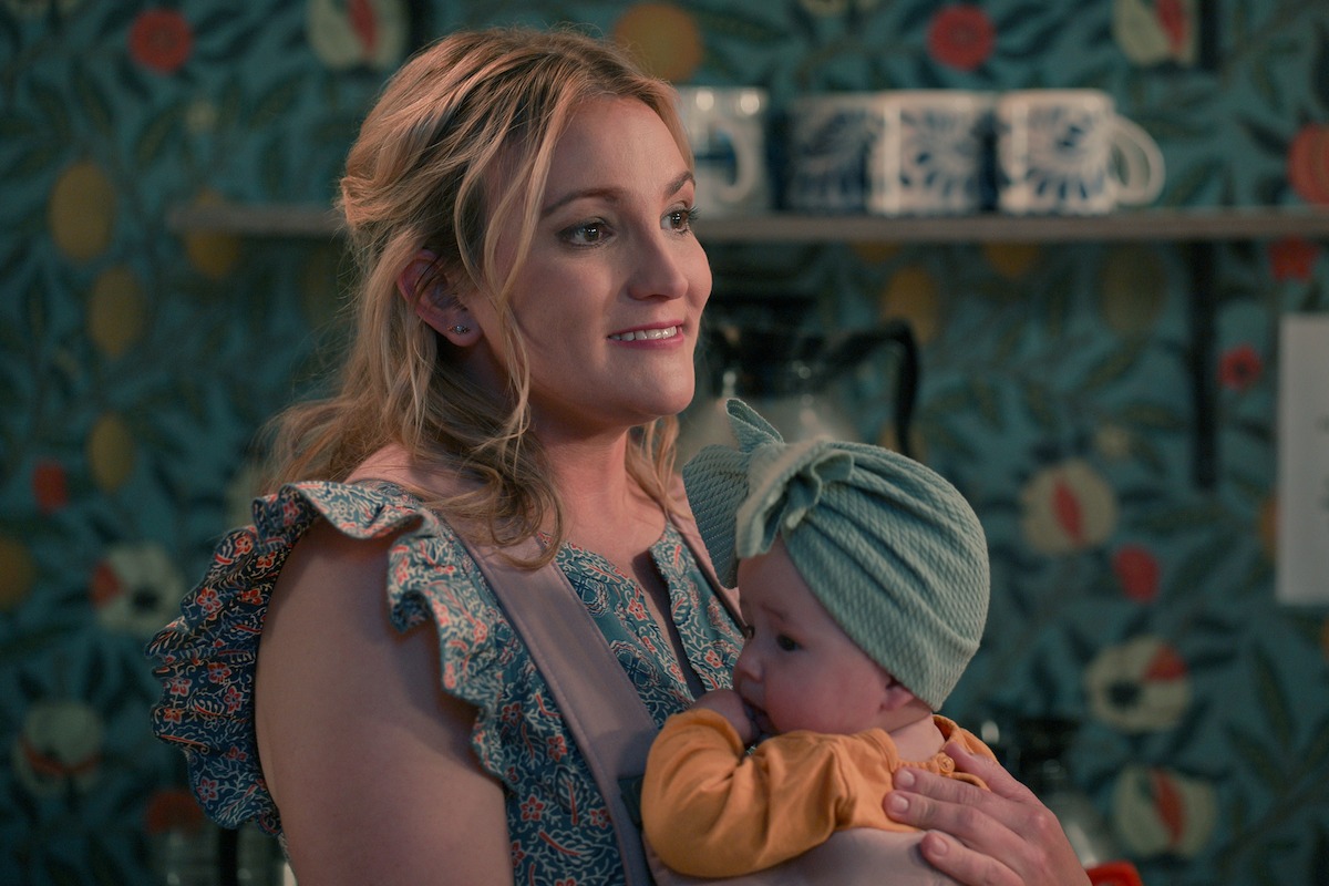 Jamie Lynn Spears as Noreen holding a baby and smiling in Season 3 of ‘Sweet Magnolias.’