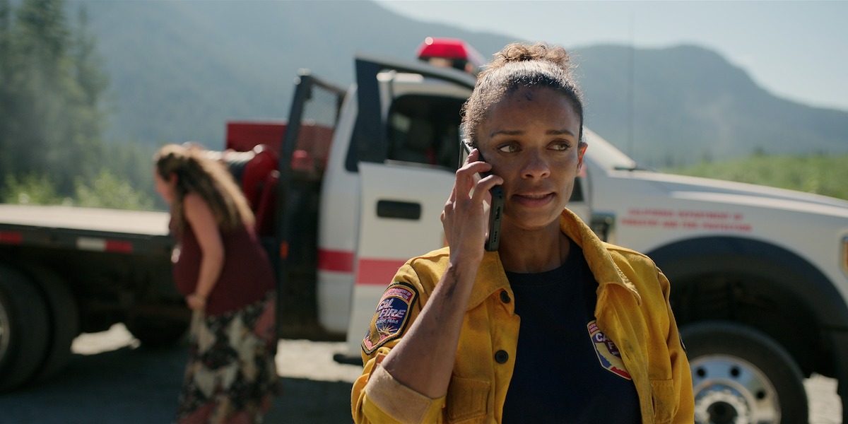 Kandyse McClure as Kaia wears a firefighter’s uniform and takes a phone call in Season 5 of ‘Virgin River.’