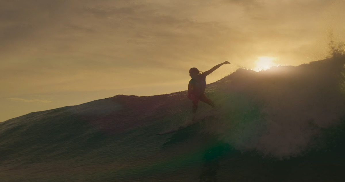 A surfer rides a wave in Season 2 of 'Surviving Summer.'