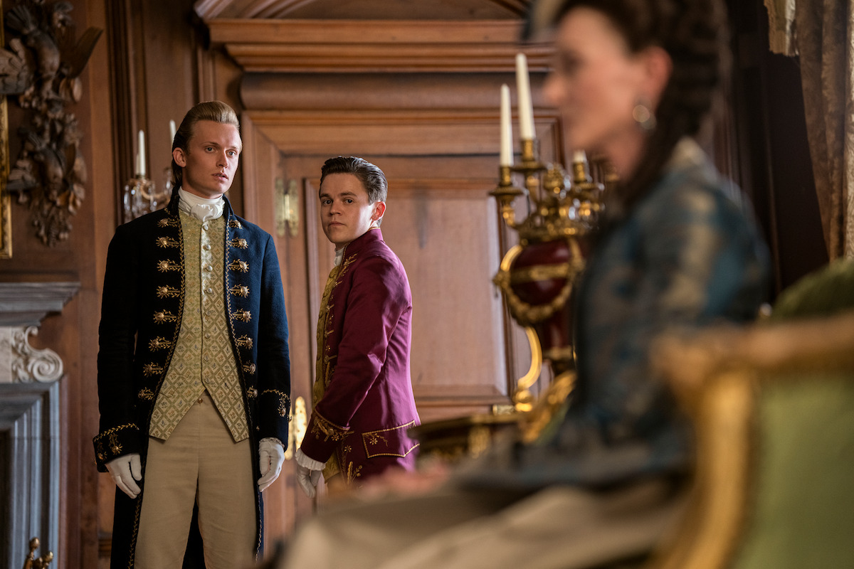 Reynolds and young Brimsley stand together looking at Princess Augusta.