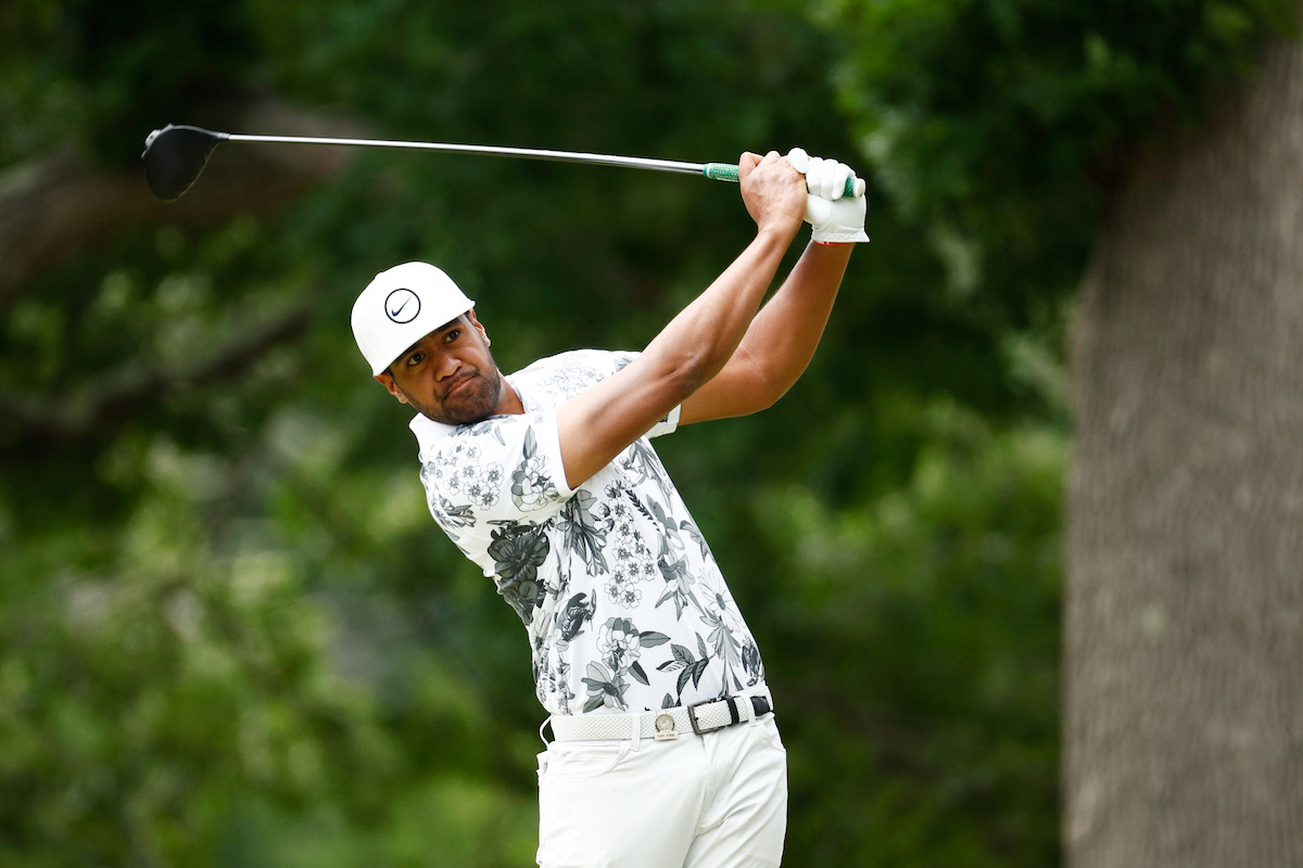 Golfer Tony Finau watches his ball after a drive.