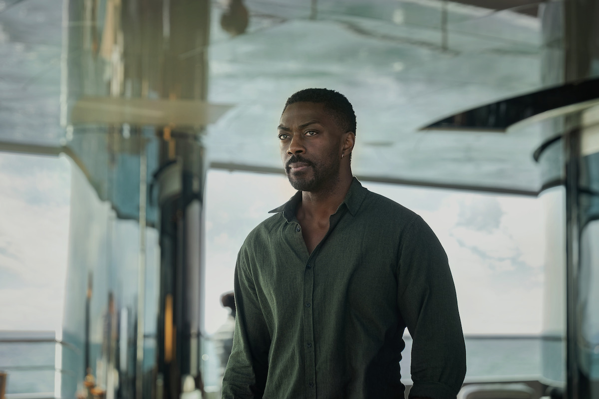 David Ajala looks suspiciously into the distance while aboard a yacht.