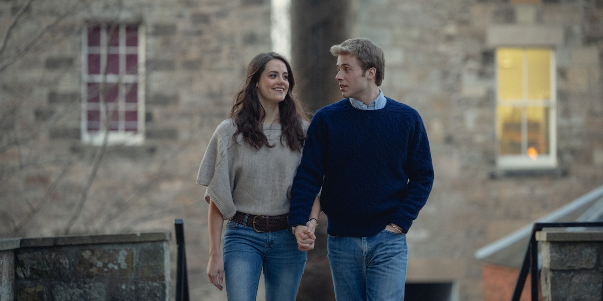 Kate and William walk together while holding hands.