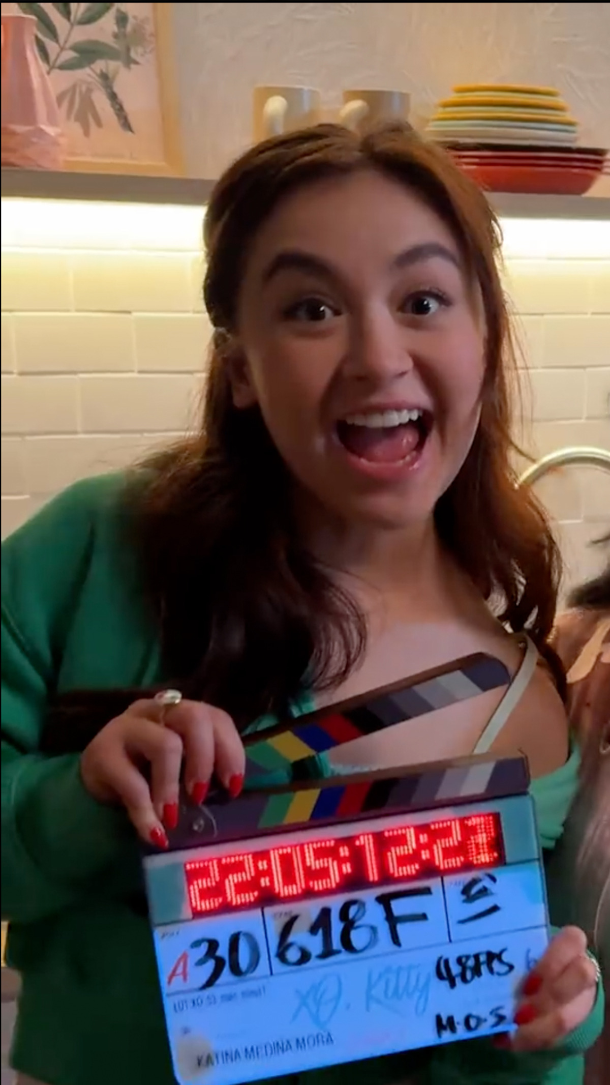 Anna Cathcart holding clapboard