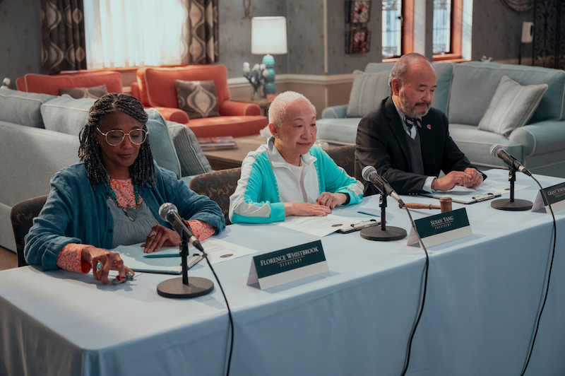 Margaret Avery as Florence, Lori Tan Chinn as Susan and Clyde Kusatsu as Grant sit at a panel table in Season 1 of 'A Man on the Inside'