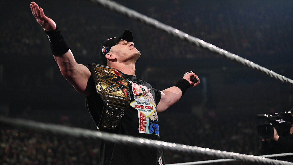 Wrestler in the ring with a championship belt, arms raised in victory, surrounded by a cheering crowd in an arena setting, dramatic lighting, energetic and triumphant mood.