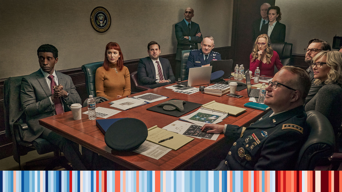 A shot of the Don't Look Up Cast sitting around a conference table. 