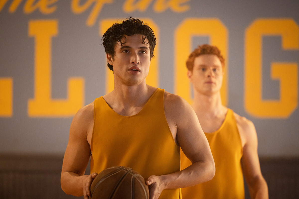 Charles Melton as Reggie Mantle wears a yellow jersey and holds a basketball in Season 7 of ‘Riverdale.’