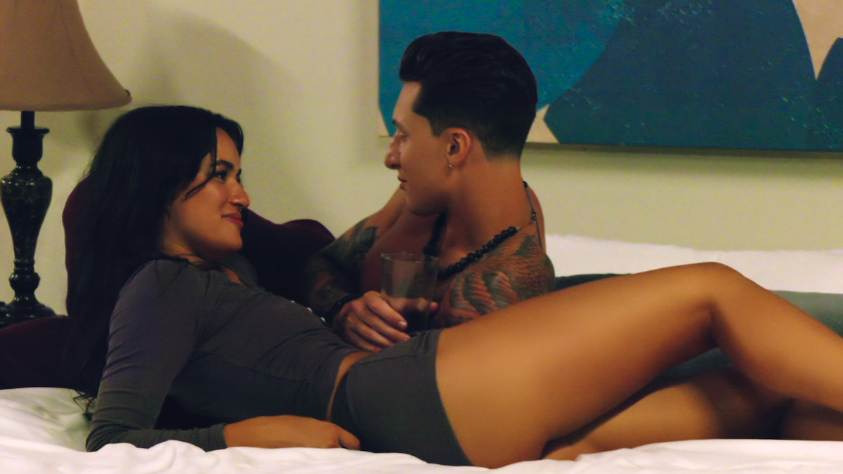 Natalie and Grant lay in bed together