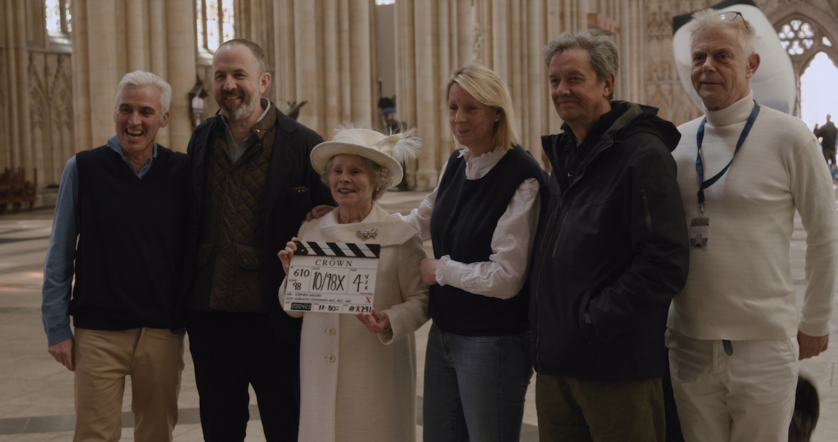 A behind the scenes moment of crew and Imelda Staunton holding a clap board for season 6 of 'The Crown'