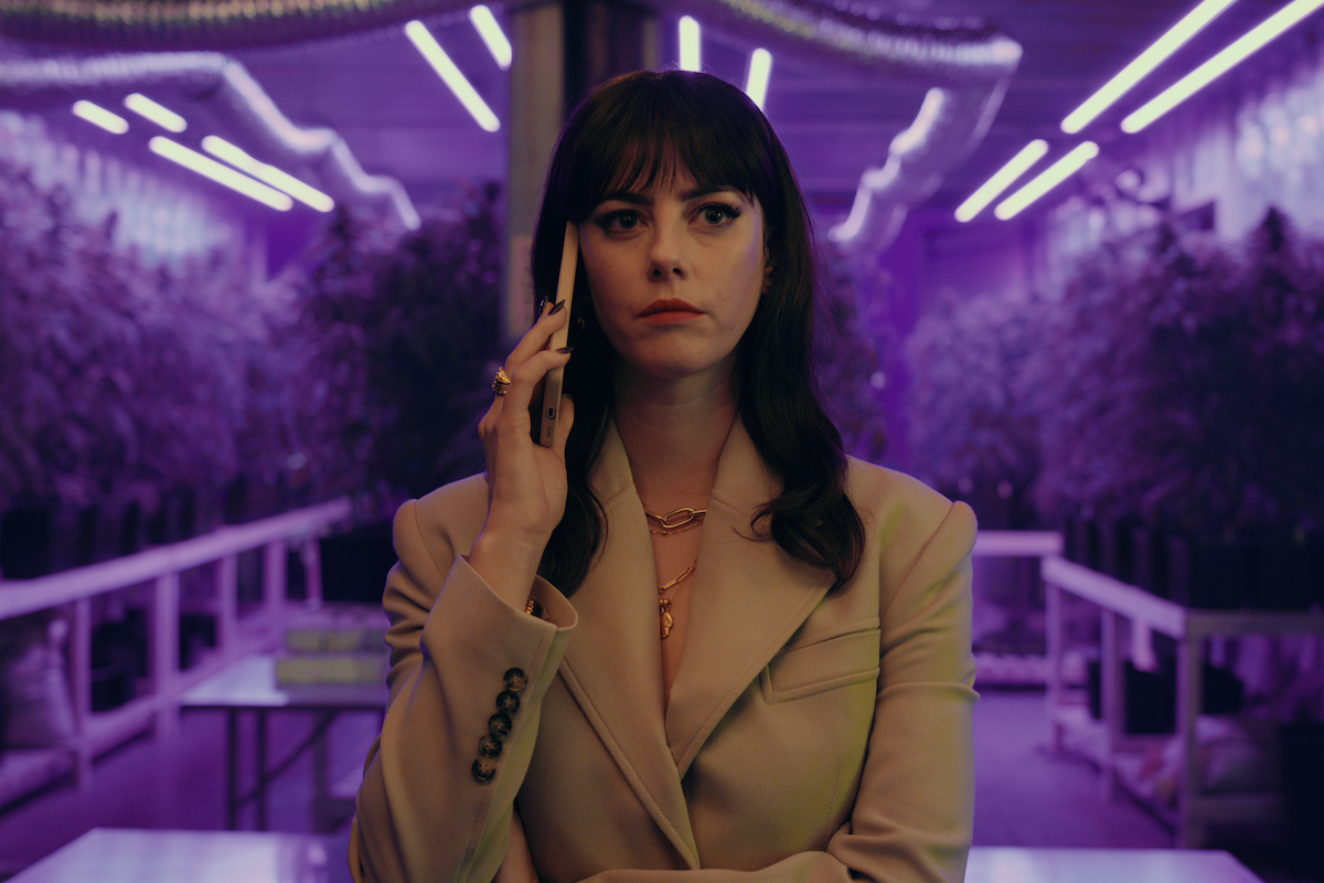 Kaya Scodelario as Susie Glass takes a phone call in a room with marijuana growing in Season 1 of ‘The Gentlemen’