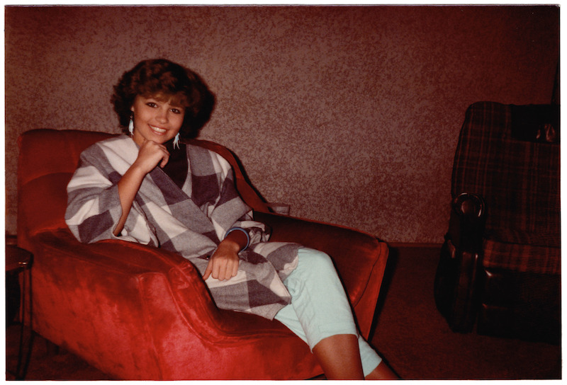 Pamela sitting in a checkered shawl.