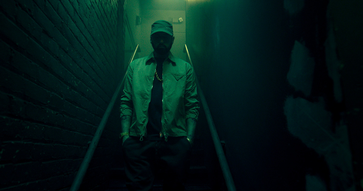 Eminem descends a dark stairwell.