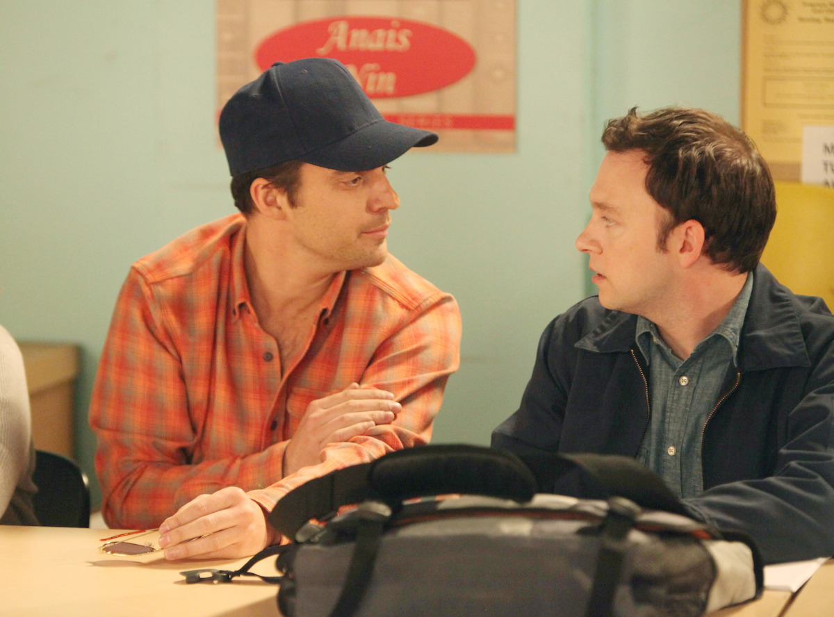 Nick in a classroom wearing a baseball cap