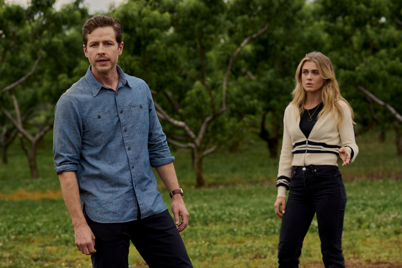 Two people standing in a field