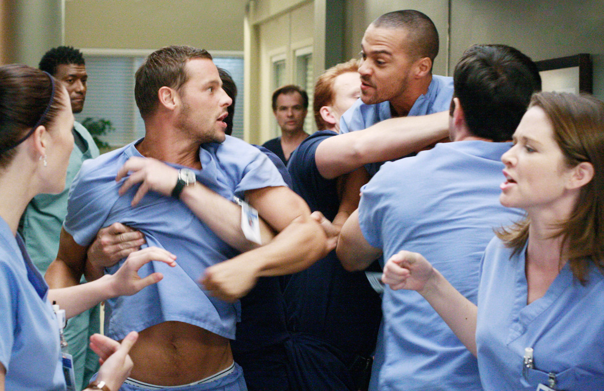 two doctors are held back from fighting. 