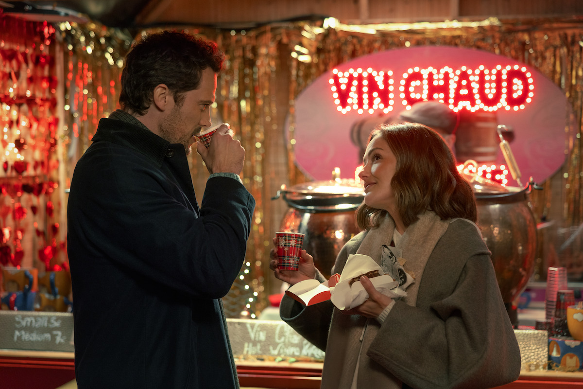 Tom Wozniczka as Henri Cassell and Minka Kelly as Sydney Price share a drink in ‘Champagne Problems.’
