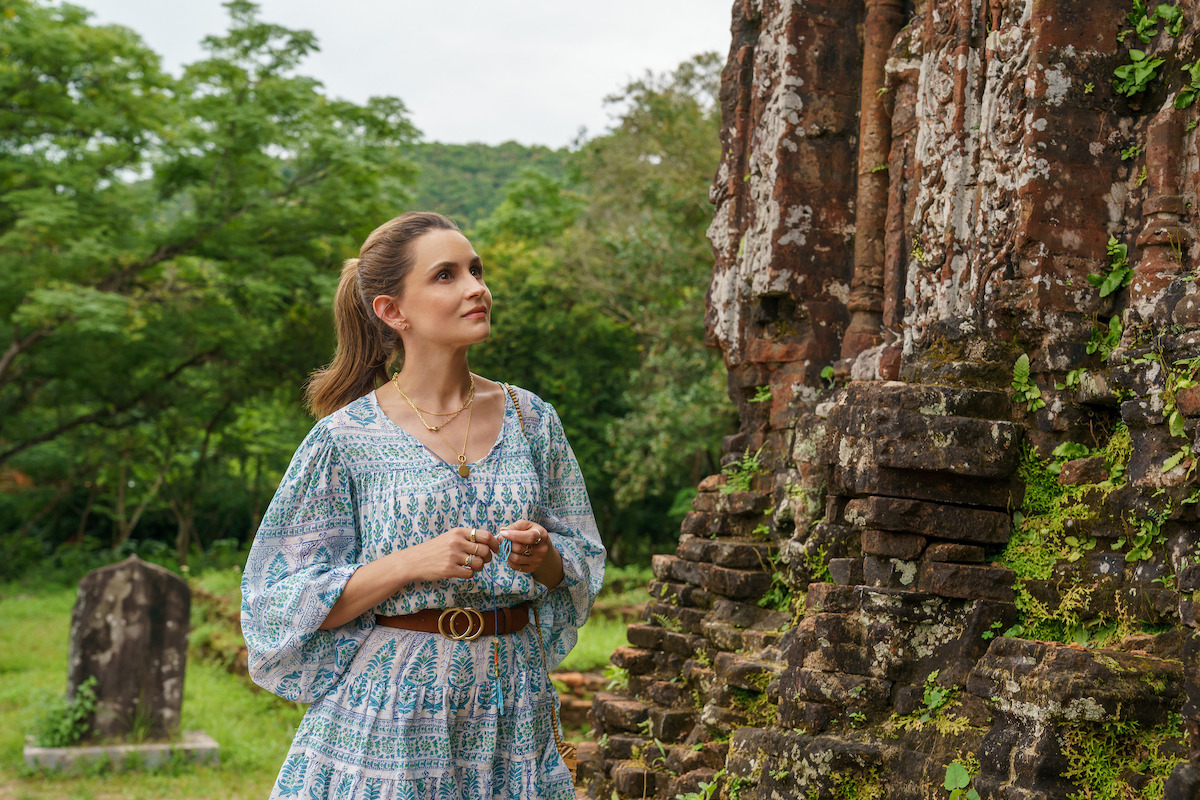 A woman explores outdoor ruins in a still from ‘A Tourist’s Guide to Love.'