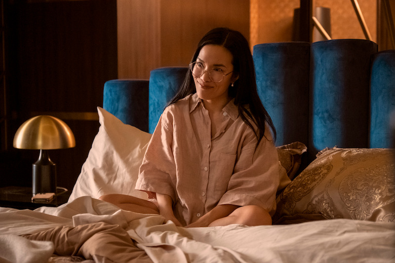 Ali Wong on a bed