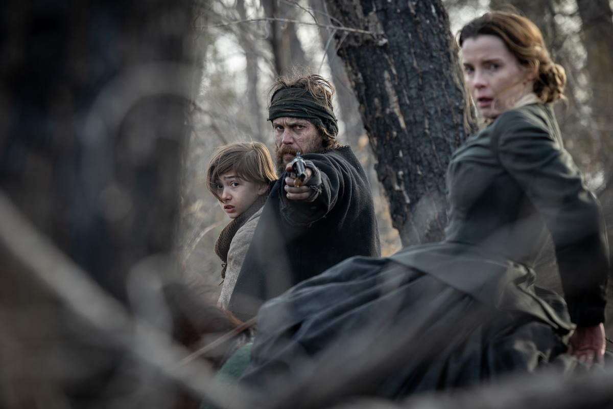 Preston Mota as Devin Rowell, Taylor Kitsch as Isaac, and Betty Gilpin as Sara Rowell in ‘American Primeval’.