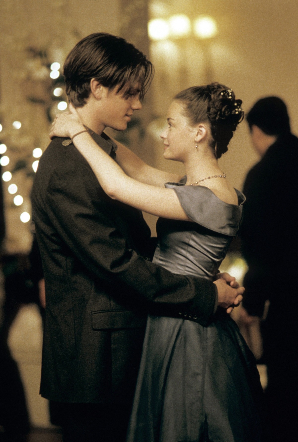 A young couple embraces at a school dance