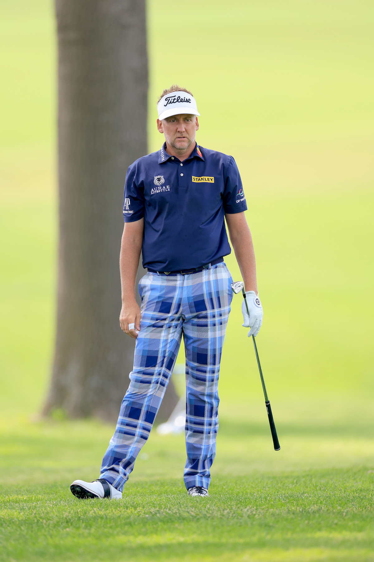 Golfer Ian Poulter plots out a shot while wearing a pair of fun plaid pants.
