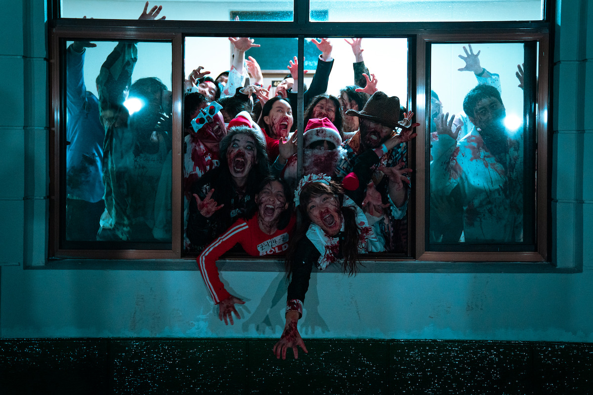 Zombies bursting out of a window in 'Zombieverse'.