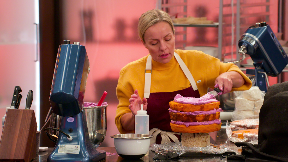 Kristen Eagles frosting a cake.