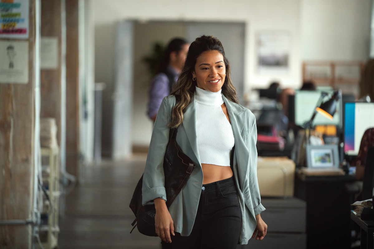 Gina Rodriguez as Mack walks into the office in ‘Players.’