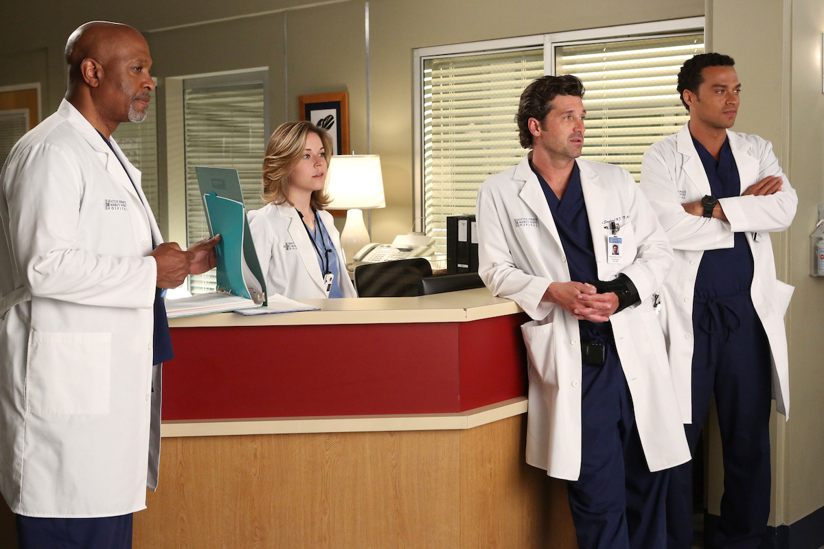 a group of doctors look offscreenm slightly amused. 