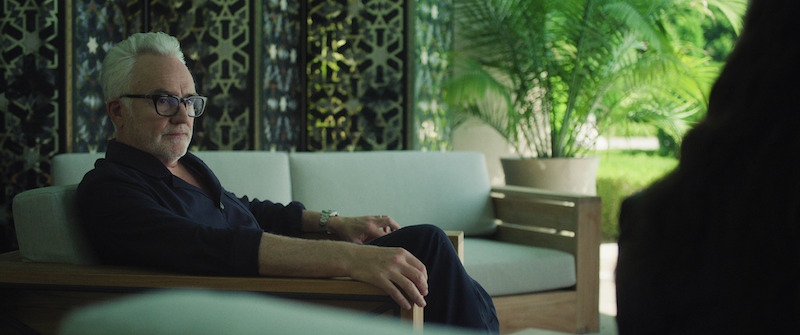 Bradley Whitford as Stu Magnusson sits on a chair in Season 1 of 'The Madness'