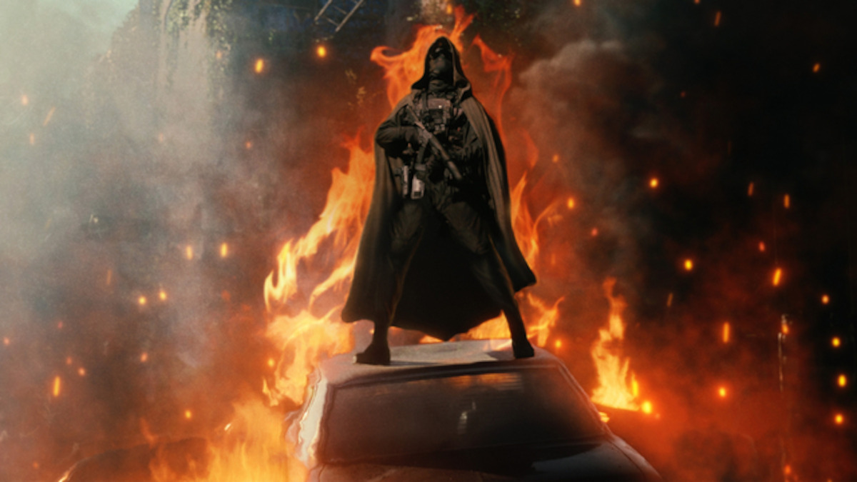 A cloaked figure surrounded by fire.