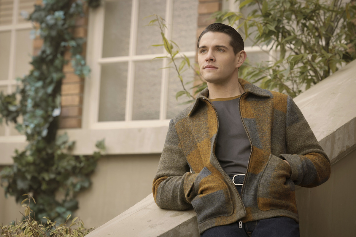 Casey Cott as Kevin Keller leans on a stairway railing in Season 7 of ‘Riverdale.’