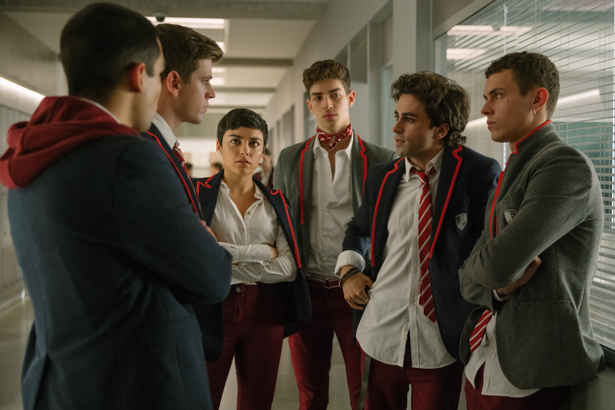  A group of six students in matching gray, red and white school uniforms.