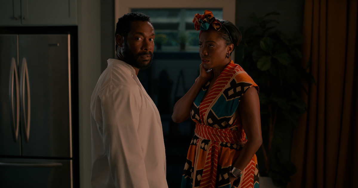 Two people standing in front of a doorway