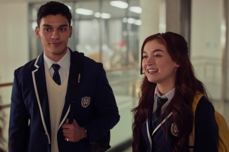 Anthony Keyvan as Quincy 'Q' Shabazian and Anna Cathcart as Kitty Song Covey stand in a hallway wearing school uniforms in Season 2 of 'XO, Kitty'